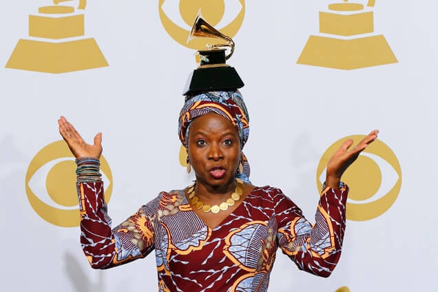 Angelique Kidjo poses with the award for best world music album for "Eve" backstage at the 57th annual Grammy Awards in Los Angeles