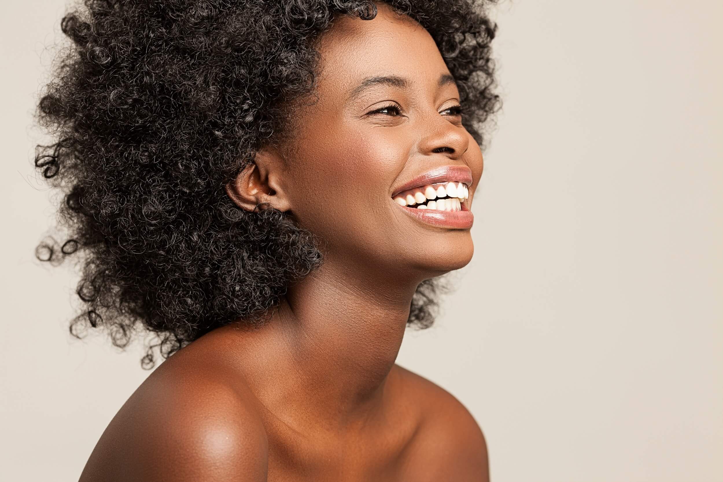 Portrait of a beautiful smiling African woman with a retro hairstyle.